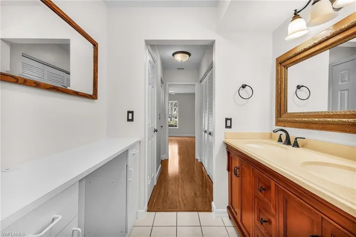 En-suite primary bathroom features dual sinks, ample cabinetry and a linen closet.