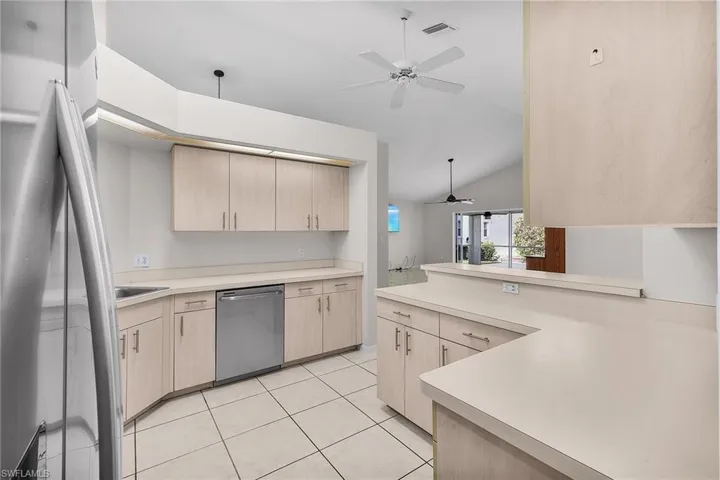 Kitchen featuring appliances with stainless steel finishes, ceiling fan, ample cabinetry.