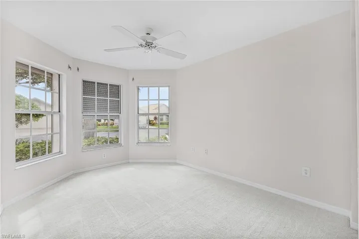 The front guest bedroom has been freshly pained and features new carpeting, ample windows with storm shutters, ceiling fan and a closet.