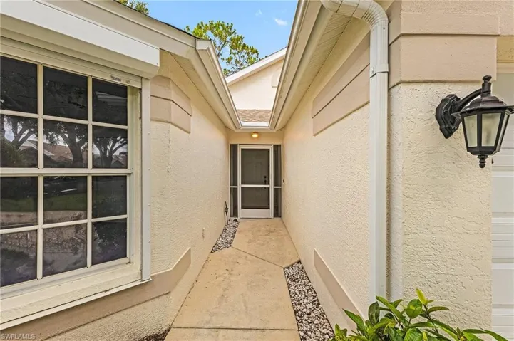 Property entrance with stucco siding