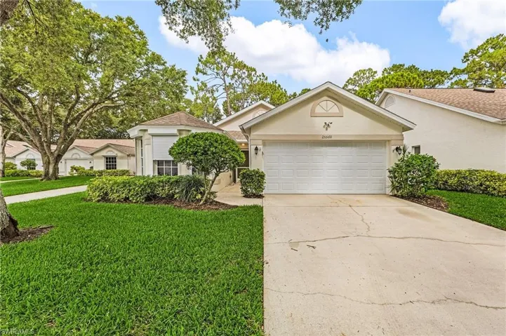 View of front of home with extended driveway and two-car garage