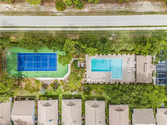 Aerial view of the community clubhouse, pool and tennis court.