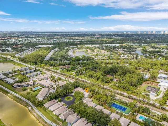 Aerial overview of property's location showing the home's close proximity to the community pool and tennis court, and the Gulf of America to the west.