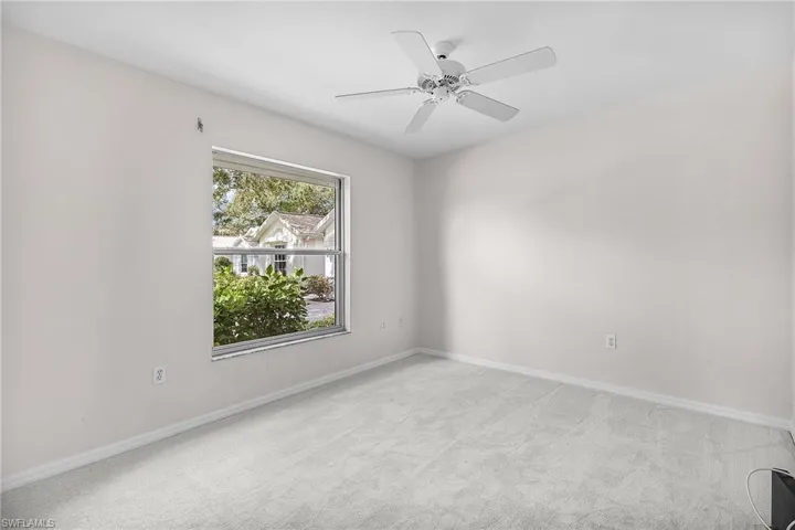 Second Guest bedroom has been freshly painted and features new carpeting, a ceiling fan, a storm shutter and a closet.