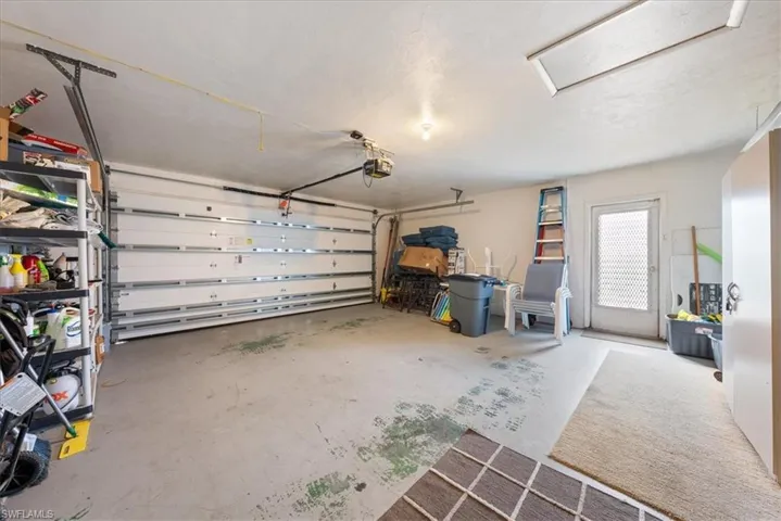 Garage featuring a garage door opener