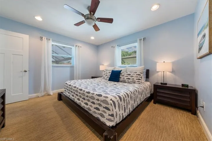 Bedroom with light colored carpet, baseboards, a ceiling fan, and recessed lighting