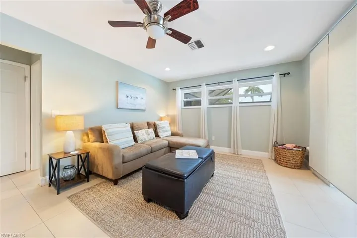 Living area featuring ceiling fan, recessed lighting, visible vents, and tile patterned floors