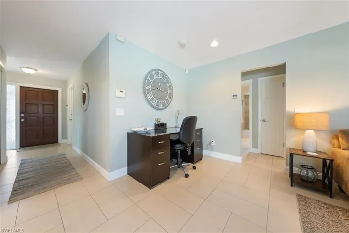 Office area with light tile patterned flooring, baseboards, and recessed lighting