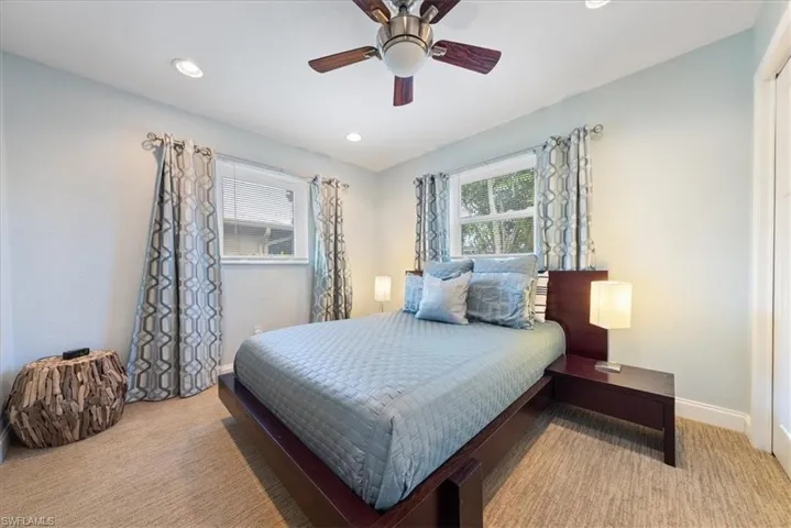 Carpeted bedroom with baseboards, recessed lighting, and a ceiling fan