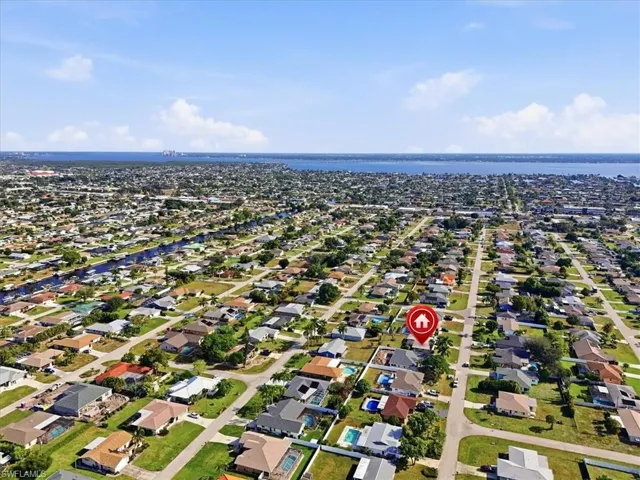 Aerial overview of property's location featuring nearby suburban area and a nearby body of water