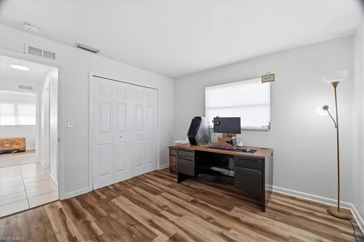 Home office featuring wood finished floors and baseboards