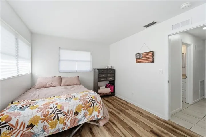 Bedroom featuring wood finished floors and baseboards