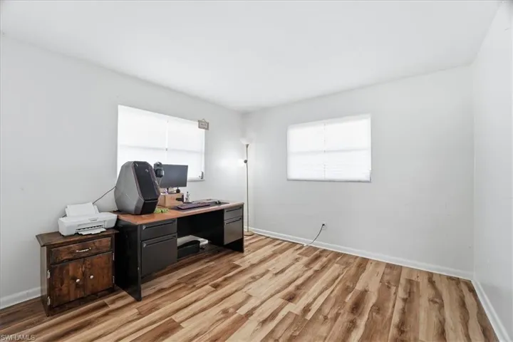 Office space featuring baseboards and light wood-style flooring