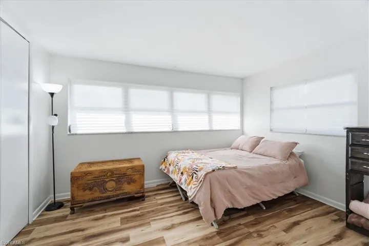 Bedroom featuring light wood-type flooring and multiple windows