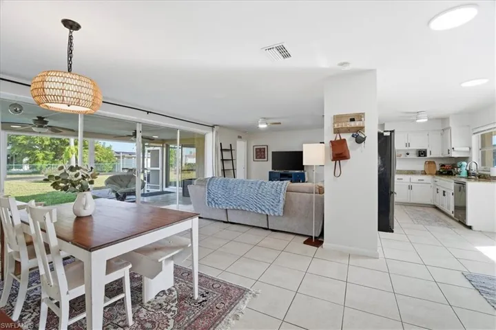 Dining room with ceiling fan and light tile patterned flooring