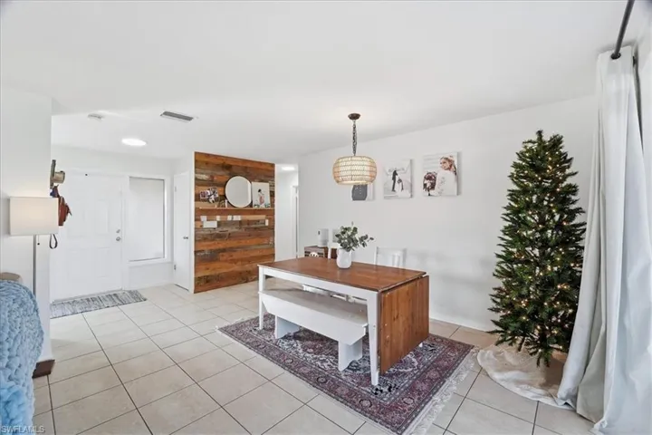 Dining room with light tile patterned flooring