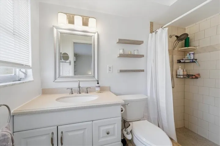 Bathroom featuring a shower stall and vanity