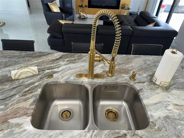 Room details featuring a sink and stone countertops