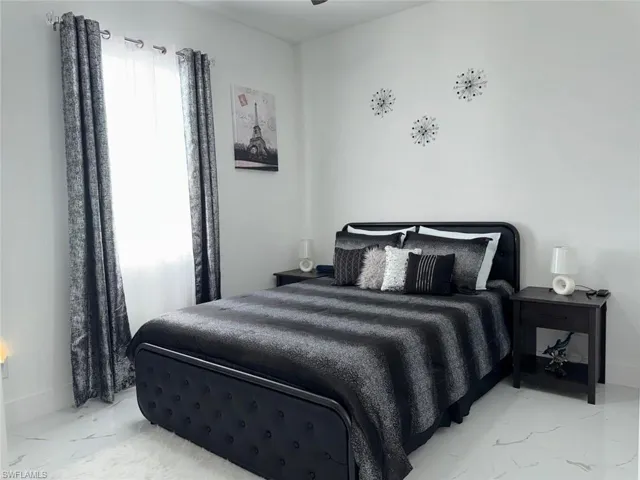 Bedroom with marble finish floor and baseboards