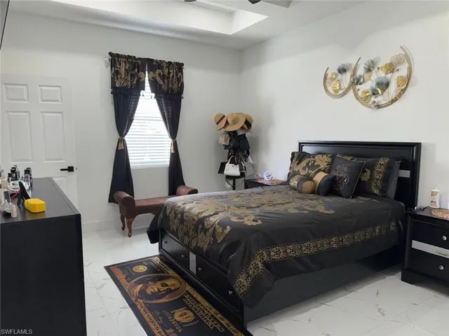 Bedroom featuring baseboards and marble finish floor