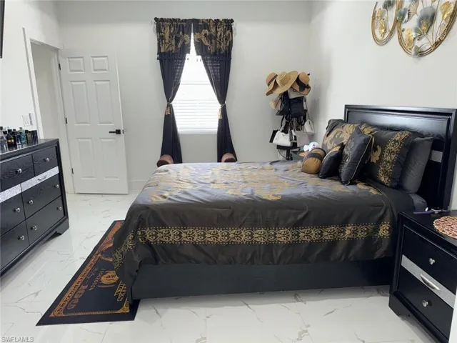 Bedroom with marble finish floor