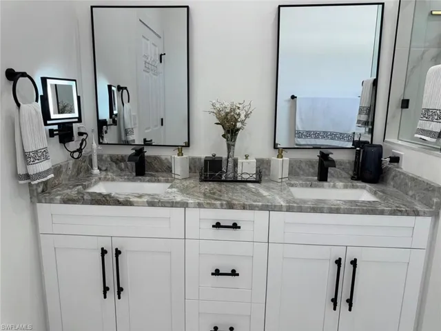 Full bath with a sink and double vanity