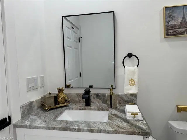 Half bathroom with toilet and vanity