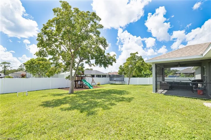 View of yard featuring a playground and ceiling fan