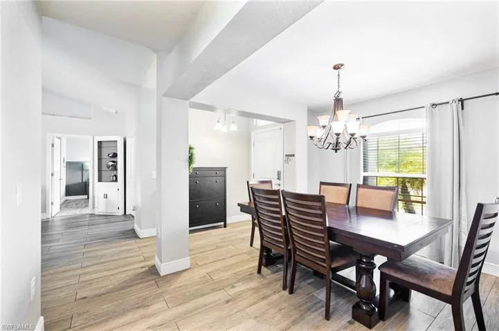 Dining room with a notable chandelier and light hardwood / wood-style floors