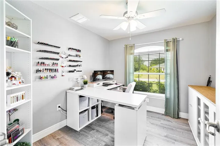 Office space with light hardwood / wood-style flooring, beverage cooler, and ceiling fan