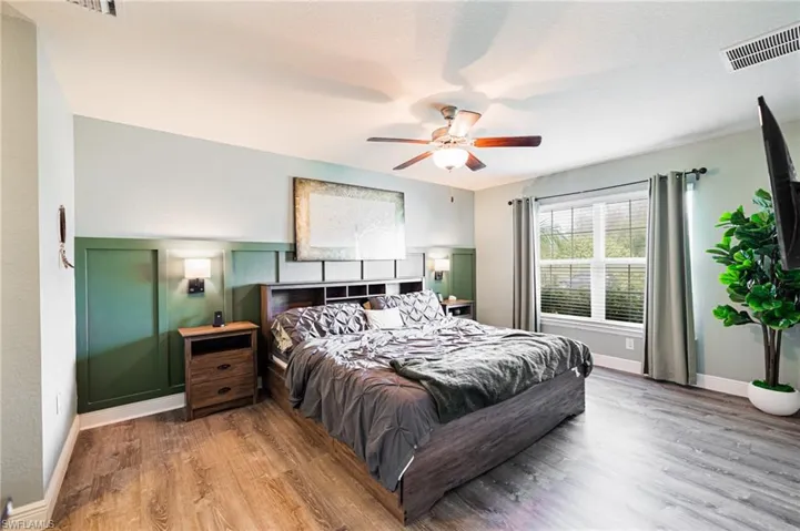 Bedroom with wood-type flooring and ceiling fan