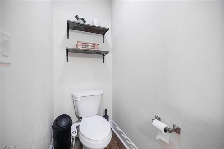 Bathroom with hardwood / wood-style floors and toilet