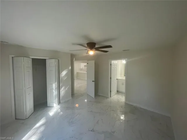Unfurnished bedroom featuring ceiling fan and a closet