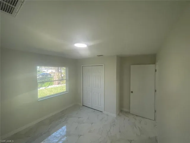 Unfurnished bedroom with a closet