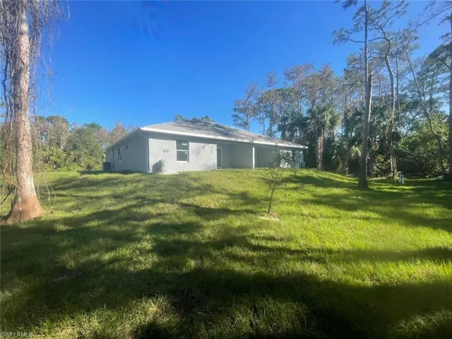 Rear view of property featuring a yard