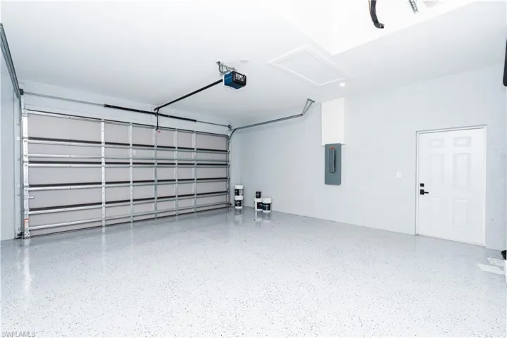 Garage with electric panel and a garage door opener