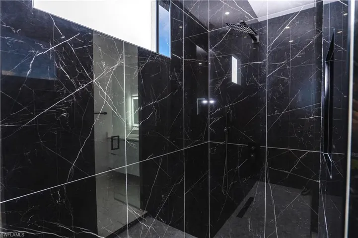 Bathroom view of a marble finish shower