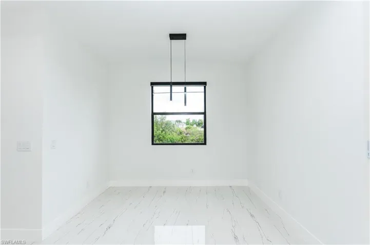 Empty room with light marble finish flooring and baseboards