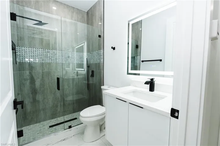 Bathroom with vanity and a shower stall
