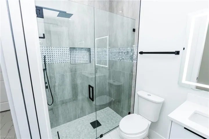 Bathroom with vanity and a shower stall
