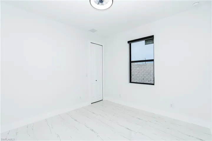 Empty room featuring baseboards and light marble finish floors