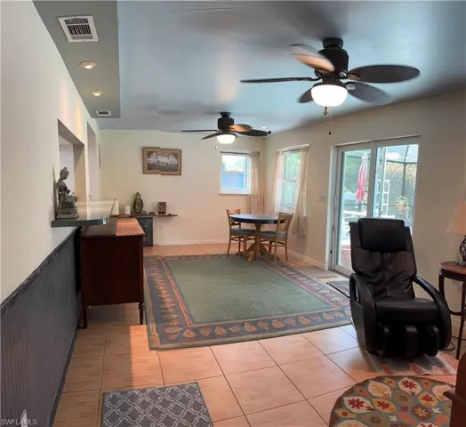 Dining space featuring light tile patterned flooring and ceiling fan