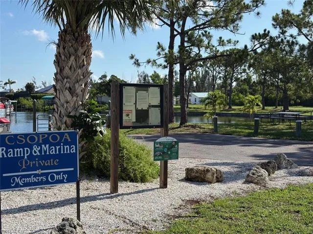 View of community with park area and a water view