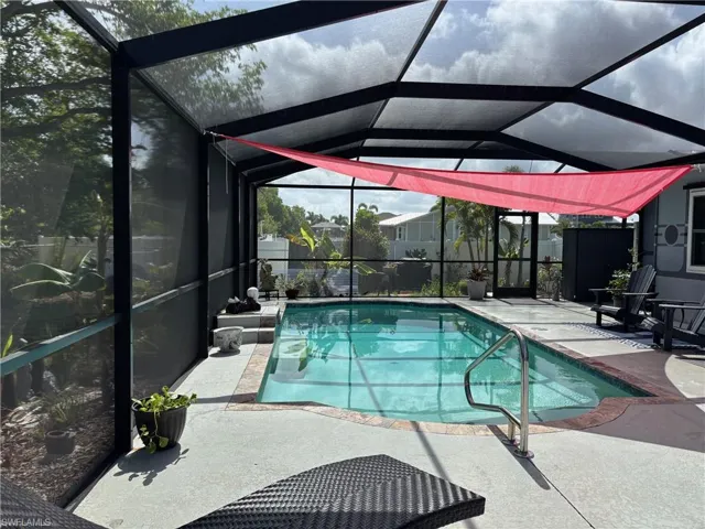 Swimming pool with a patio and a lanai