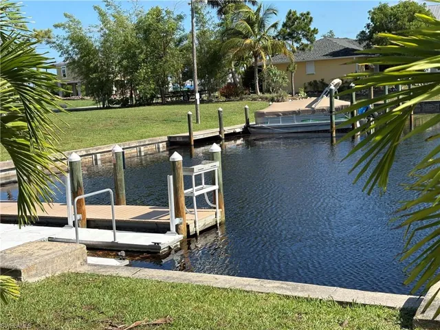 Dock featuring a water view and a lawn