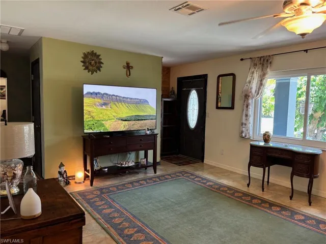 Foyer featuring a ceiling fan and tile patterned floors