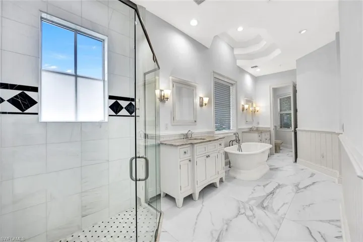 Primary bath-room with walk in shower, soaking tub and 2 vanities.