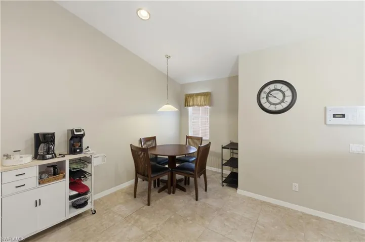 Dining space featuring baseboards and vaulted ceiling