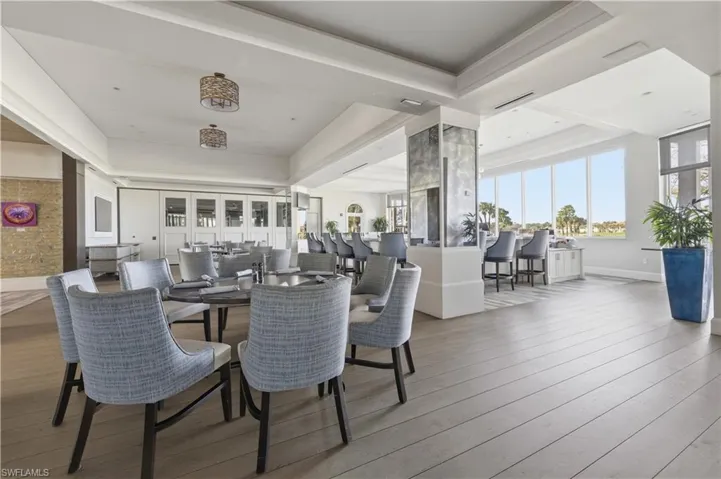 Dining area with light wood-style flooring and a tray ceiling