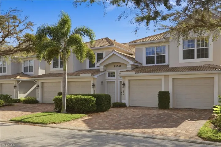Mediterranean / spanish-style home featuring an attached garage, a tile roof, driveway, and stucco siding